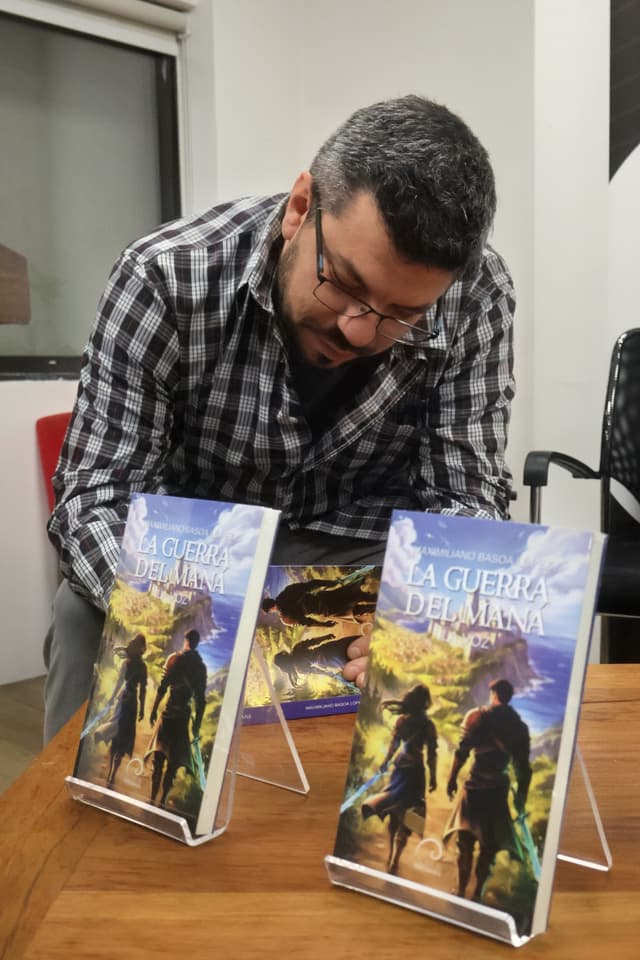 Maximiliano Basoa López firmando ejemplares de La Guerra del Maná